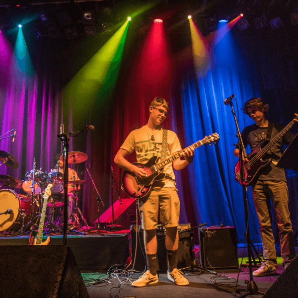 The Lesson Studio student performing at a live event on stage.