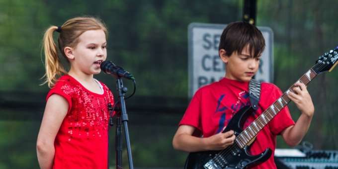 Young Wrenn Van on stage singing. 
