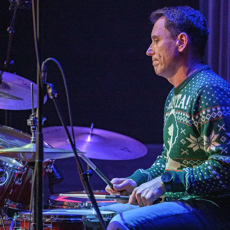 An adult Lesson Studio student playing drums